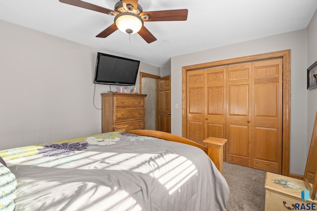 carpeted bedroom featuring a closet and a ceiling fan