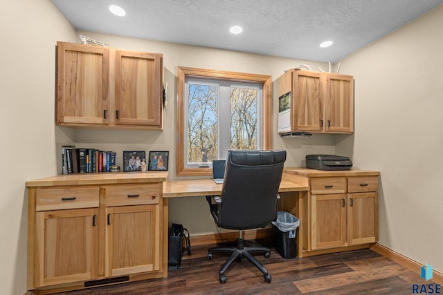 home office featuring dark wood-style floors, built in desk, and baseboards