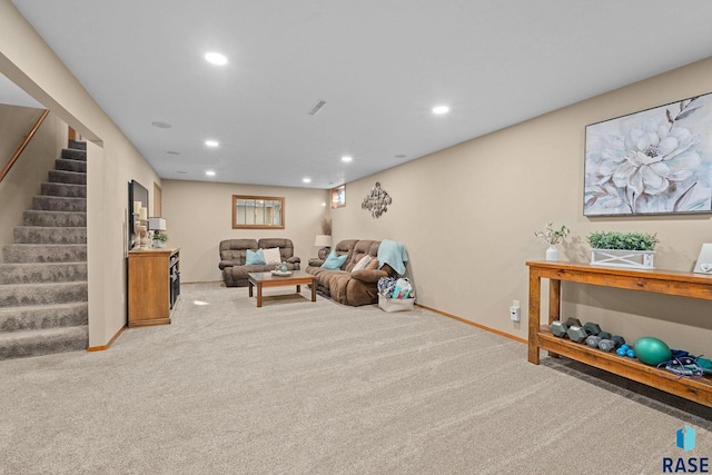 carpeted living area with recessed lighting, baseboards, and stairs