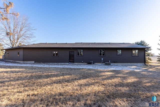 back of property featuring central AC