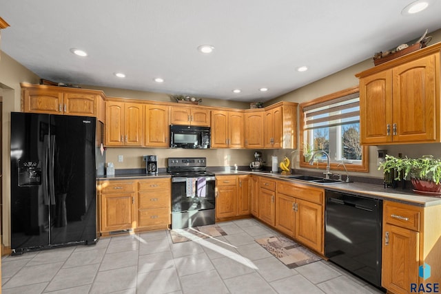 kitchen with brown cabinetry, recessed lighting, a sink, and black appliances