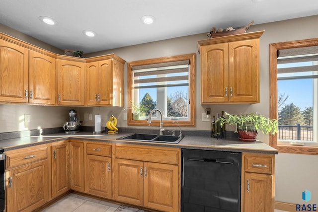 kitchen featuring black dishwasher, light tile patterned flooring, a sink, and recessed lighting