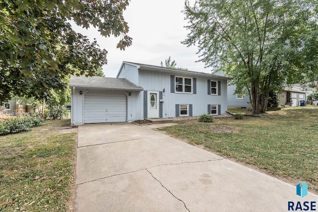 view of front of home with driveway, an attached garage, and a front yard