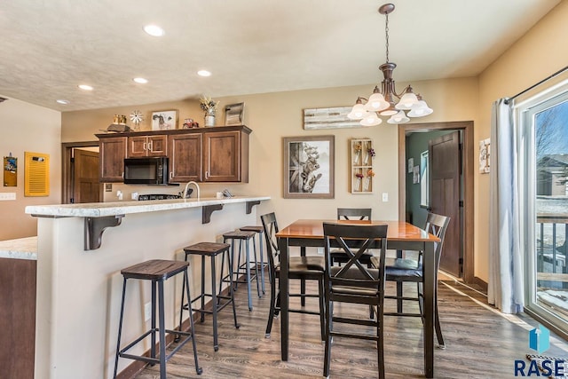 dining room featuring plenty of natural light, a chandelier, dark wood finished floors, and recessed lighting