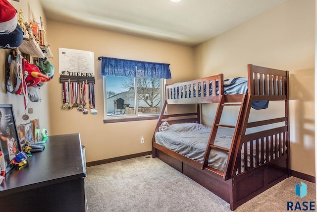 carpeted bedroom featuring baseboards