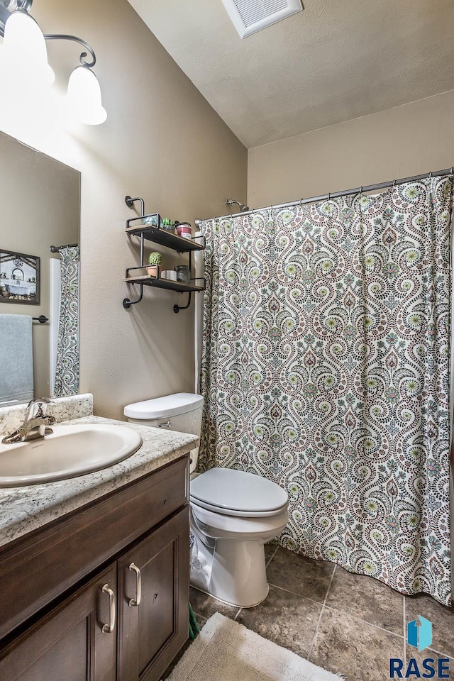 full bathroom featuring visible vents, a shower with shower curtain, toilet, vanity, and a textured ceiling