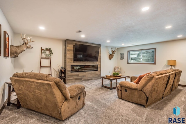 living room with carpet floors, a large fireplace, visible vents, and recessed lighting