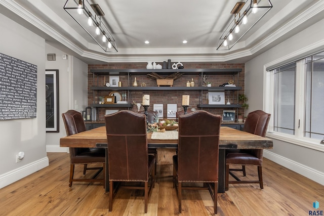 dining area featuring baseboards, wood finished floors, and track lighting