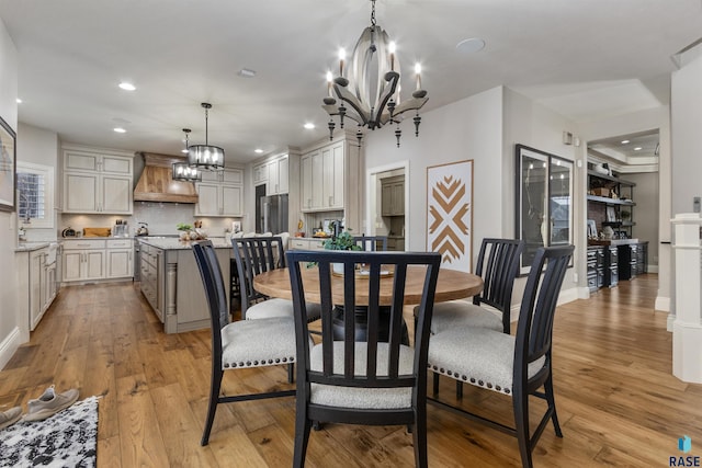 dining area with light wood-style flooring and recessed lighting