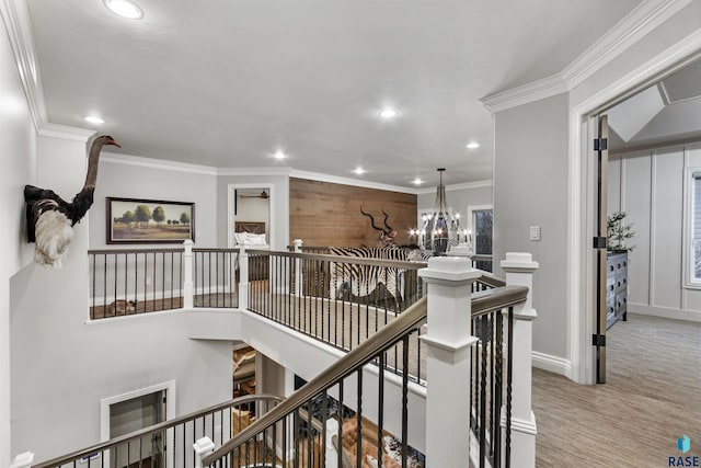 hall featuring ornamental molding, recessed lighting, an upstairs landing, and a notable chandelier