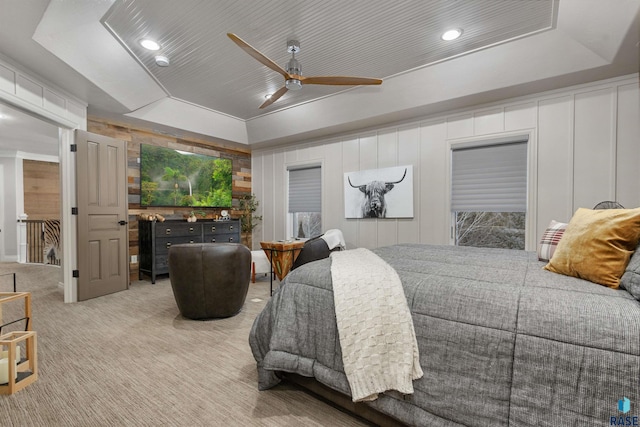 carpeted bedroom featuring a raised ceiling, a ceiling fan, and recessed lighting