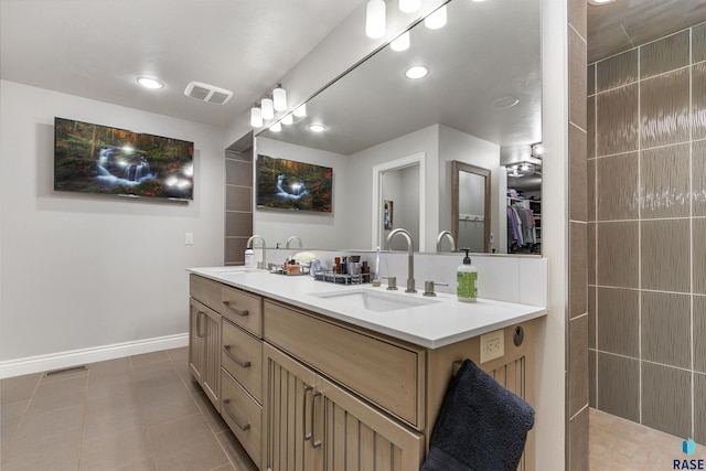 bathroom with tile patterned floors, visible vents, a sink, and double vanity