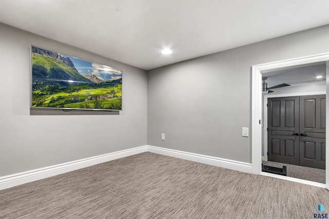 carpeted spare room with recessed lighting, ceiling fan, and baseboards