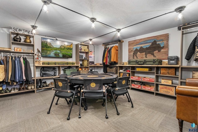 carpeted dining space featuring a textured ceiling