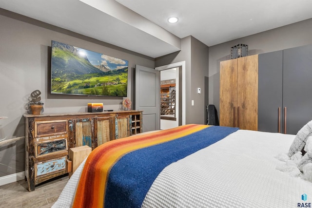 bedroom with baseboards and wood finished floors