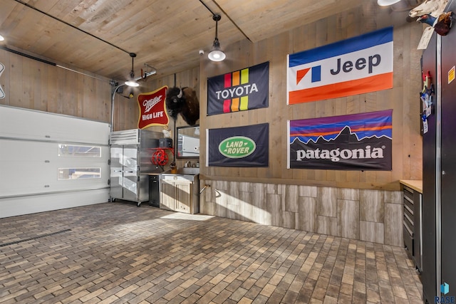 garage with wooden ceiling and wood walls