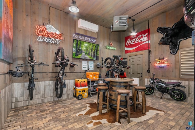 interior space with a wall mounted air conditioner, wood ceiling, and wooden walls