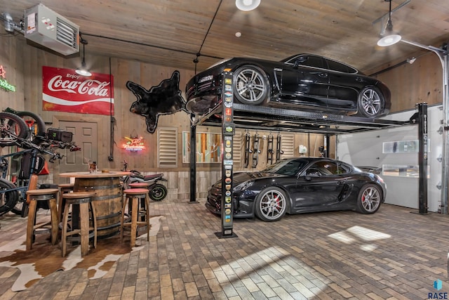 garage featuring wood walls and wooden ceiling