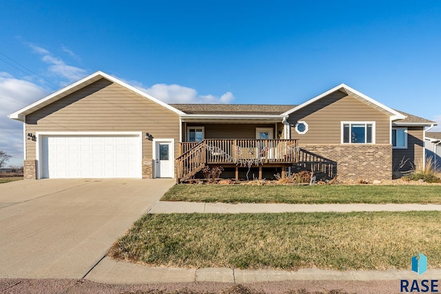 ranch-style house featuring a garage, concrete driveway, brick siding, and a front lawn