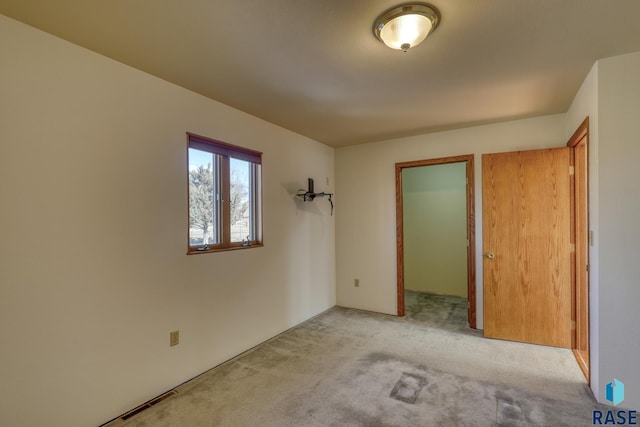 unfurnished bedroom with light colored carpet