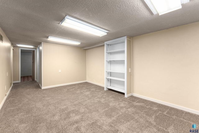 finished basement with carpet, baseboards, and a textured ceiling