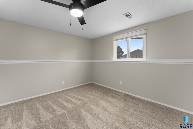 spare room with baseboards, visible vents, and carpet flooring