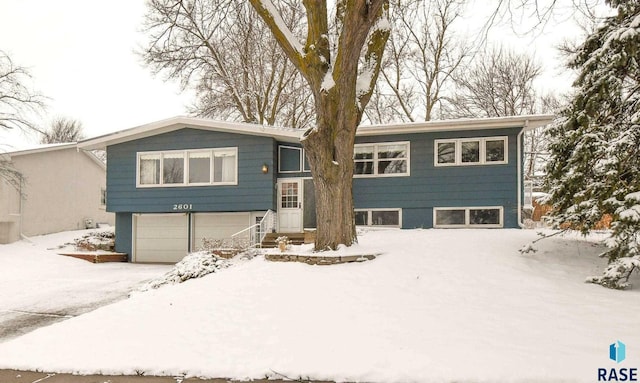 raised ranch with a garage and entry steps