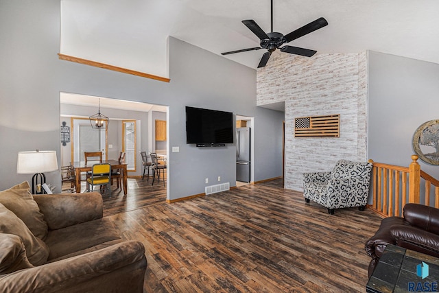 living room featuring visible vents, wood finished floors, high vaulted ceiling, baseboards, and ceiling fan with notable chandelier