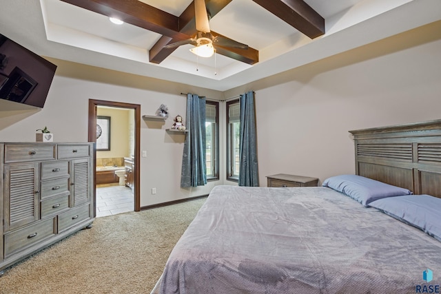 bedroom with ensuite bath, beam ceiling, baseboards, and light carpet
