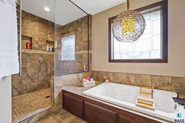 full bath featuring a tub with jets and walk in shower
