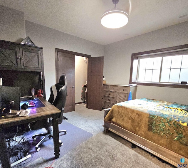 carpeted bedroom featuring visible vents