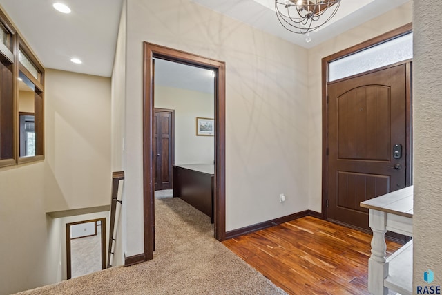 entryway with recessed lighting, an inviting chandelier, baseboards, and wood finished floors