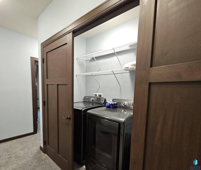 clothes washing area featuring laundry area, washing machine and dryer, baseboards, and carpet floors