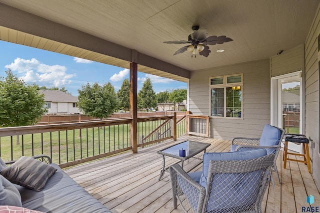 wooden deck featuring an outdoor living space, a yard, a ceiling fan, and fence
