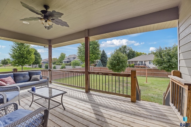 wooden terrace with an outdoor living space, a yard, a fenced backyard, ceiling fan, and a residential view