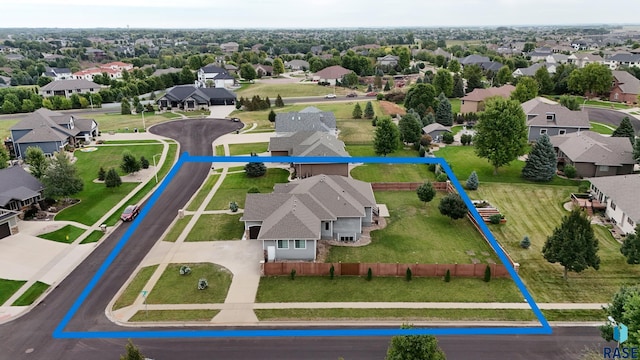 birds eye view of property with a residential view