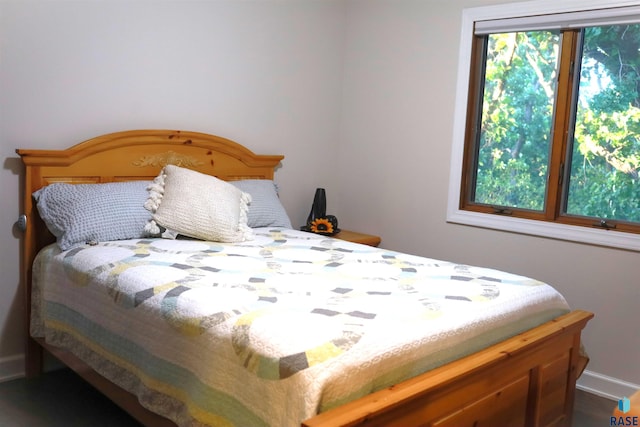 bedroom featuring multiple windows and baseboards