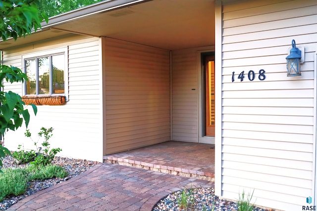 entrance to property with a patio