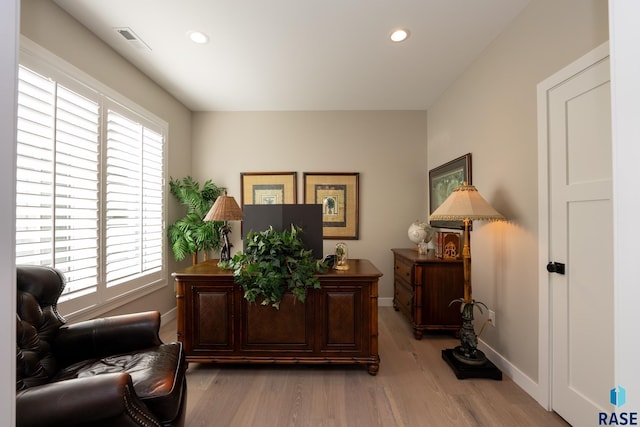 office space with baseboards, recessed lighting, a wealth of natural light, and light wood-style floors