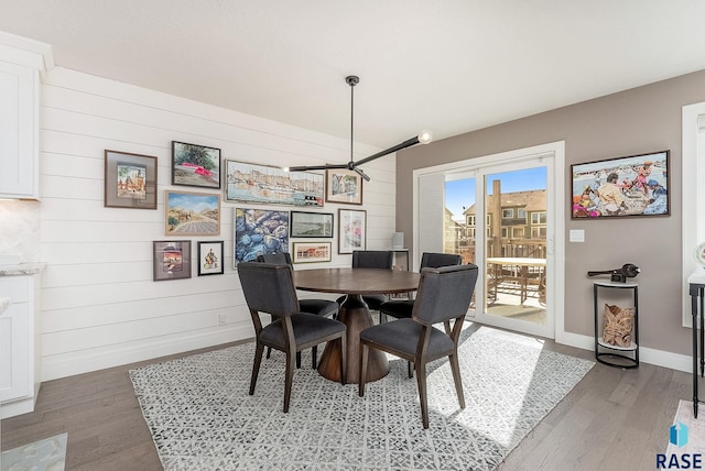 dining room featuring light wood-style floors and baseboards