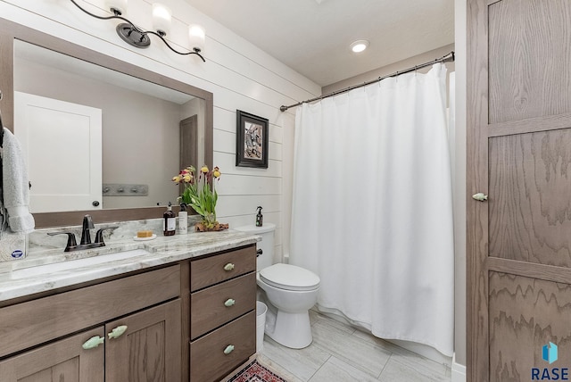 bathroom featuring curtained shower, vanity, and toilet