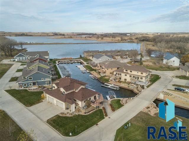 drone / aerial view featuring a residential view and a water view