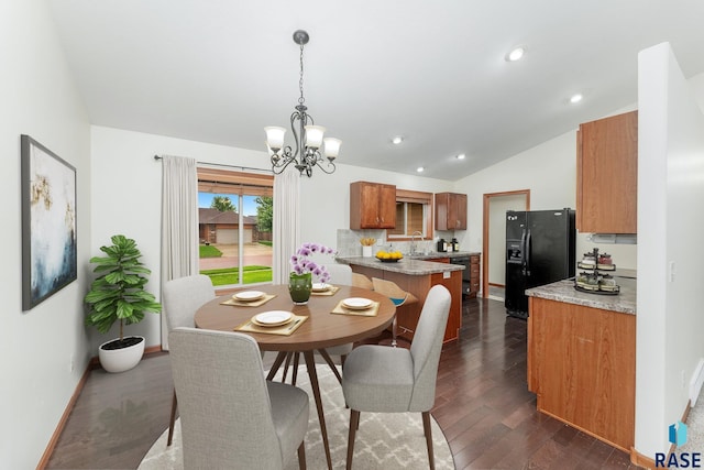 dining area featuring a notable chandelier, dark wood finished floors, recessed lighting, baseboards, and vaulted ceiling