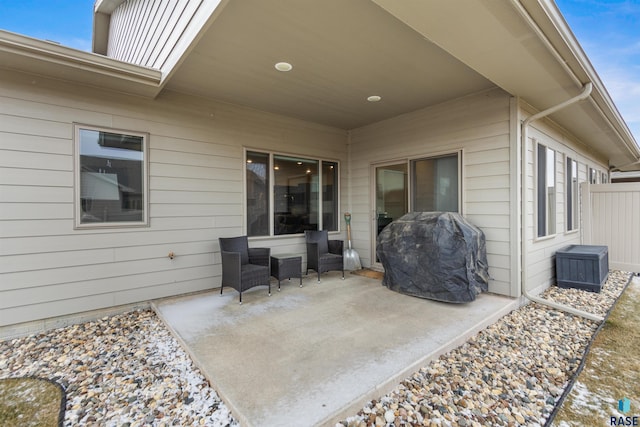 view of patio with area for grilling and fence