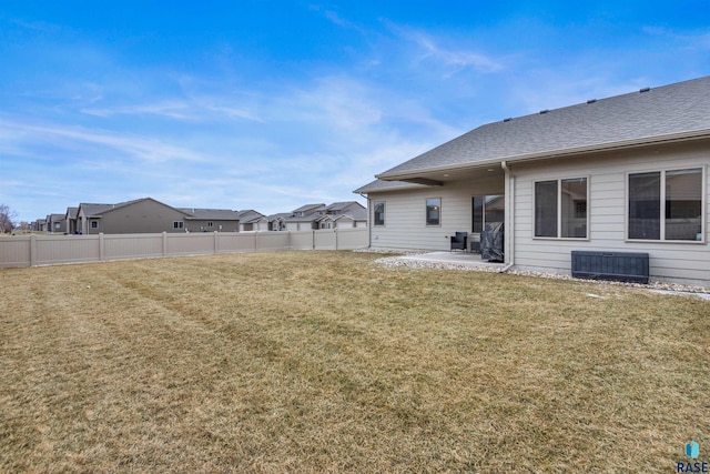 view of yard featuring central AC unit, a patio area, and fence