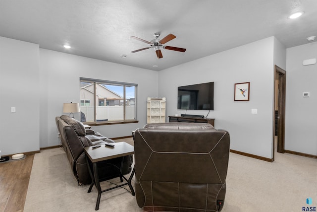 living room featuring recessed lighting, ceiling fan, light colored carpet, and baseboards