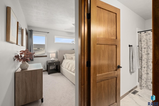 bedroom with visible vents, a textured ceiling, and marble finish floor