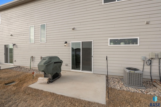 rear view of house featuring cooling unit and a patio area