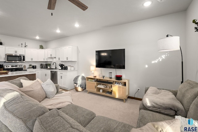 living room with recessed lighting, baseboards, light carpet, and ceiling fan