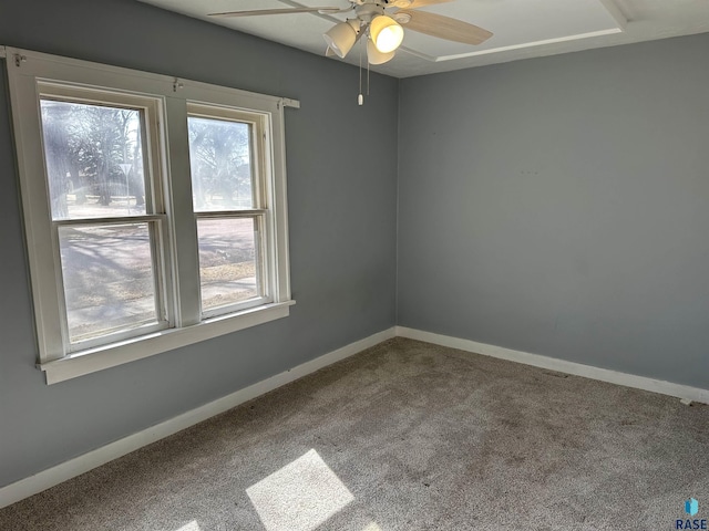 unfurnished room with ceiling fan, baseboards, and carpet